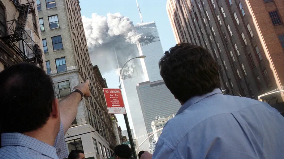 Pedestrians react to the World Trade Center collapse Sept. 11, 2001. 